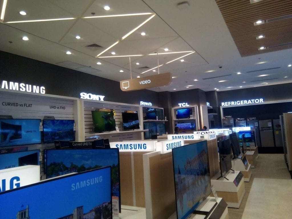 Bright indoor LED signage in an electronics store with TVs and appliances, Quezon City location by M&G Global Ads.
