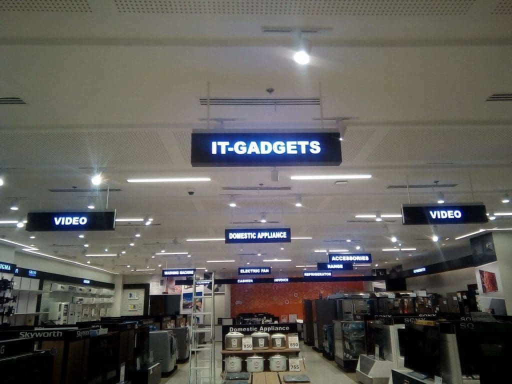 Acrylic signage for electronics store, featuring “IT-GADGETS” in Quezon City, with shelves of gadgets by M&G Global Ads.