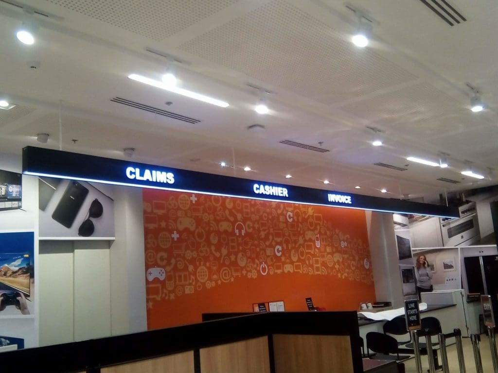 Illuminated acrylic signage for CLAIMS, CASHIER, and INVOICE at a service counter in Makati by M&G Global Ads.