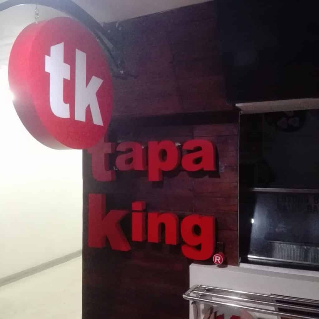 Tapa King 3D building signage in Makati with red TK logo and white letters on dark wood wall, by M&G Global Ads.