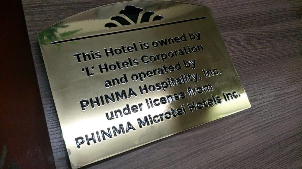 Metal hotel sign for PHINMA Hospitality, Inc. on wood in Makati, by M&G Global Ads.