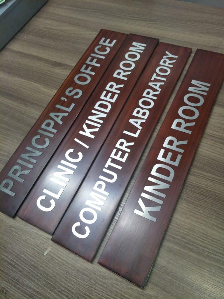 Wooden door signage for schools in Quezon City: PRINCIPALS OFFICE, CLINIC, KINDER ROOM, COMPUTER LAB by M&G Global Ads.
