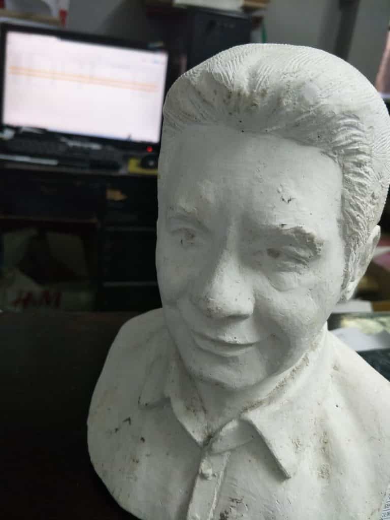 Indoor office signage for a Quezon City client on a computer, with white plaster bust by M&G Global Ads.