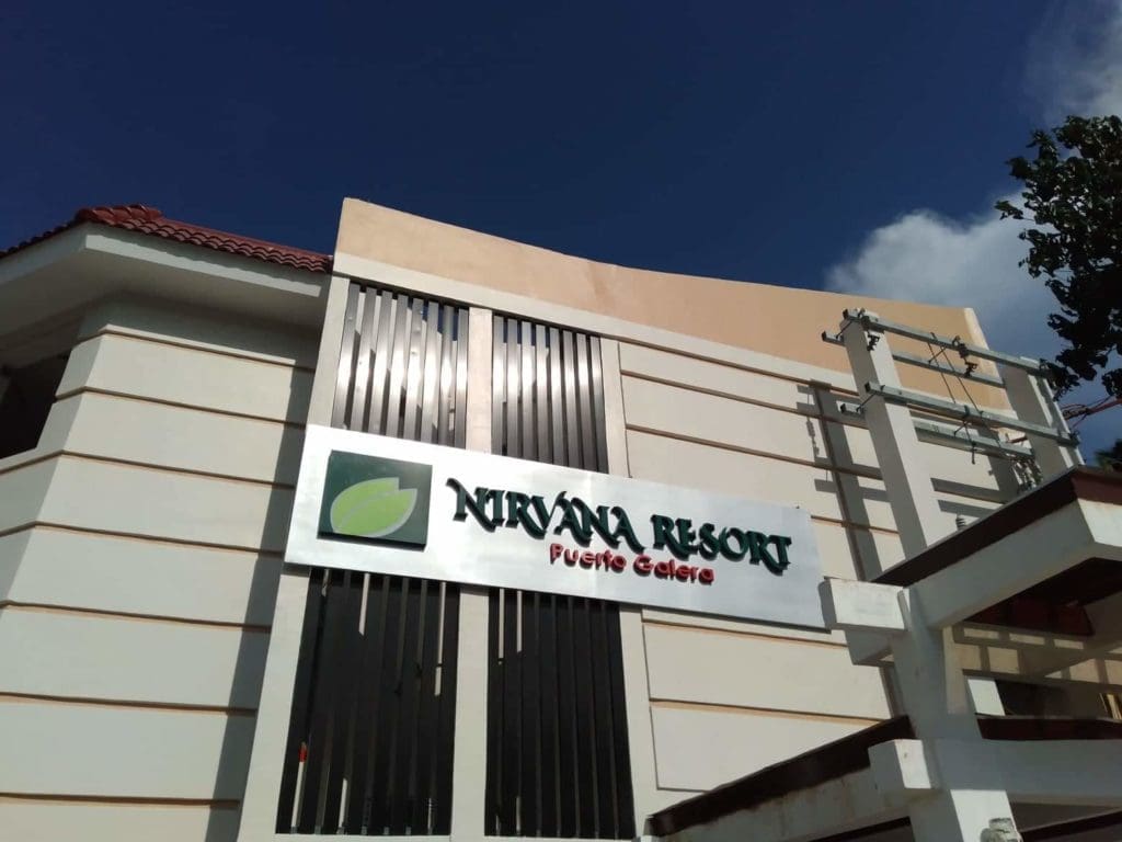 Acrylic signage for Nirvana Resort Puerto Galera on a modern white building, Makati location. By M&G Global Ads.