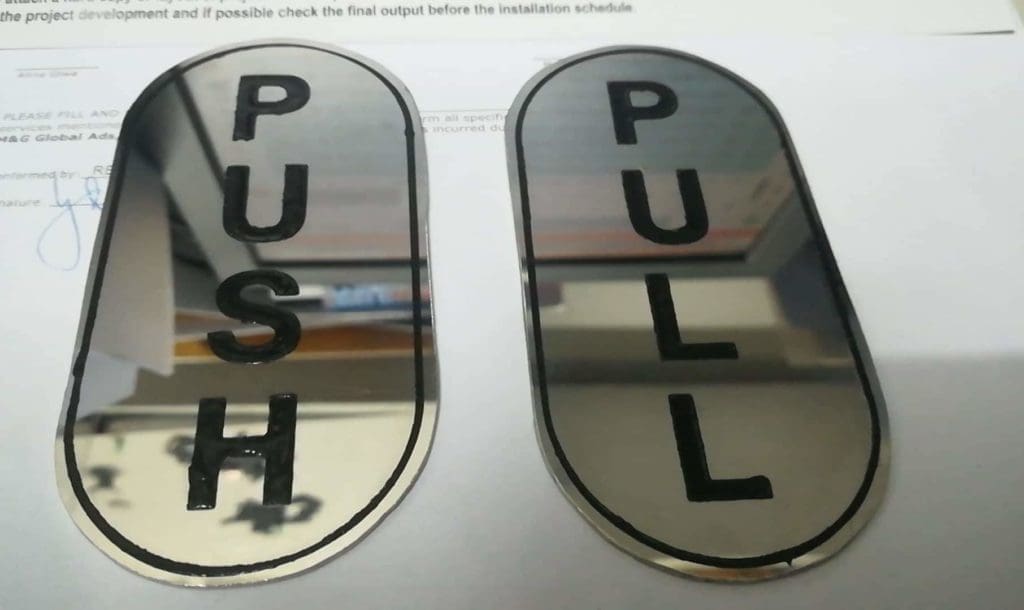 Door push pull oval signage plates with mirrored finish and black borders in Makati by M&G Global Ads.