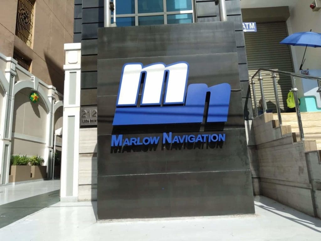 Marlow Navigation black metallic outdoor signage near building entrance in Makati, with blue and white logo, by M&G Global Ads.