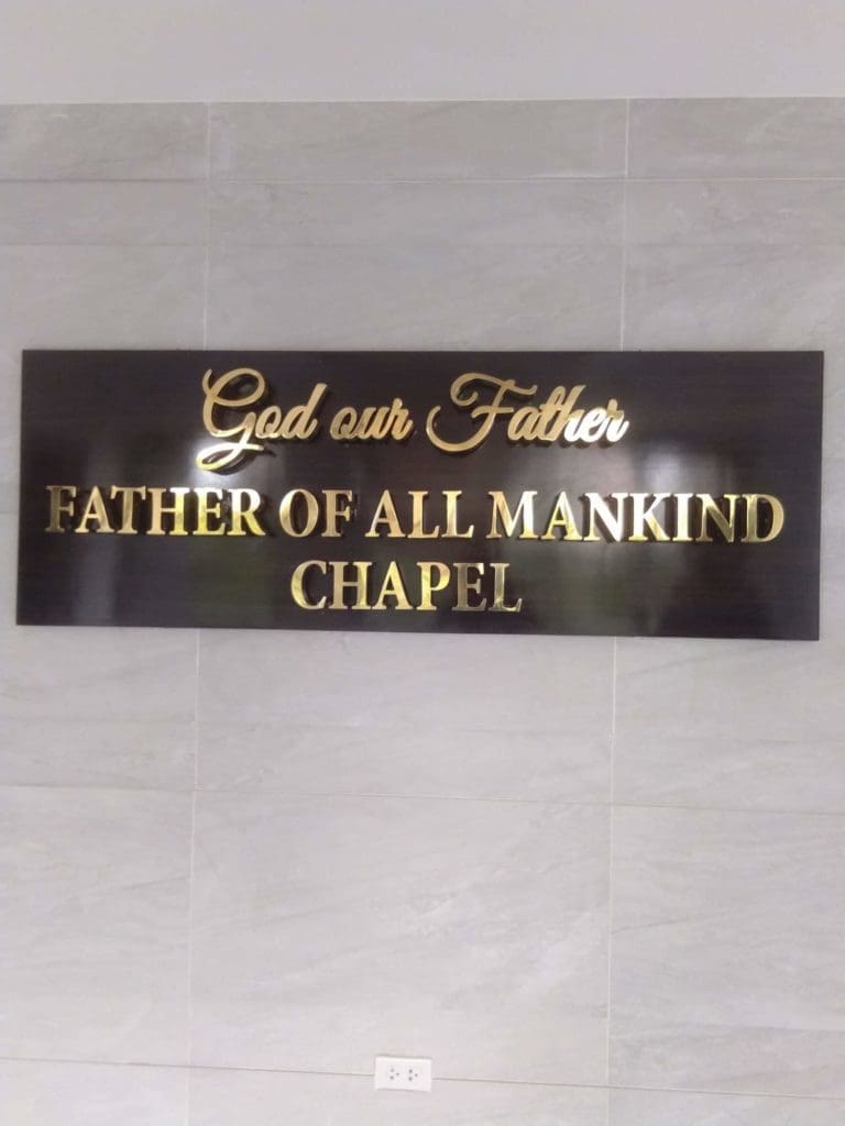 Acrylic wall signage for God our Father FATHER OF ALL MANKIND CHAPEL in Makati on gray tiles by M&G Global Ads.