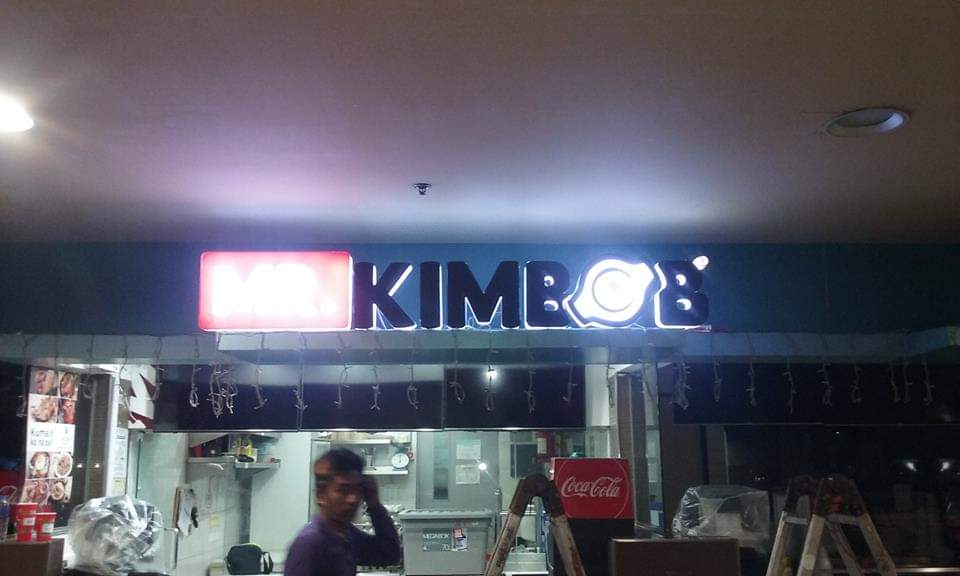 Outdoor restaurant signage for MR. KIMBOB in Mandaluyong, neon letters with bowl logo and person in front, by M&G Global Ads.