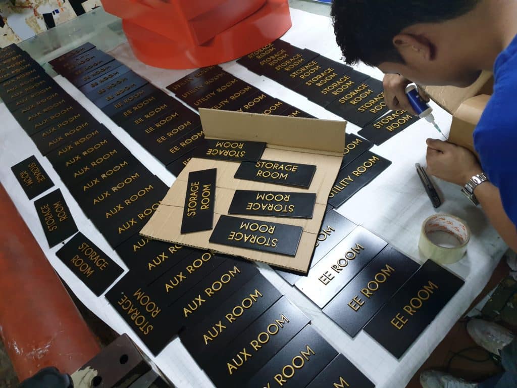 Custom black metallic indoor office signs for storage and aux rooms in Makati, with tools, by M&G Global Ads.