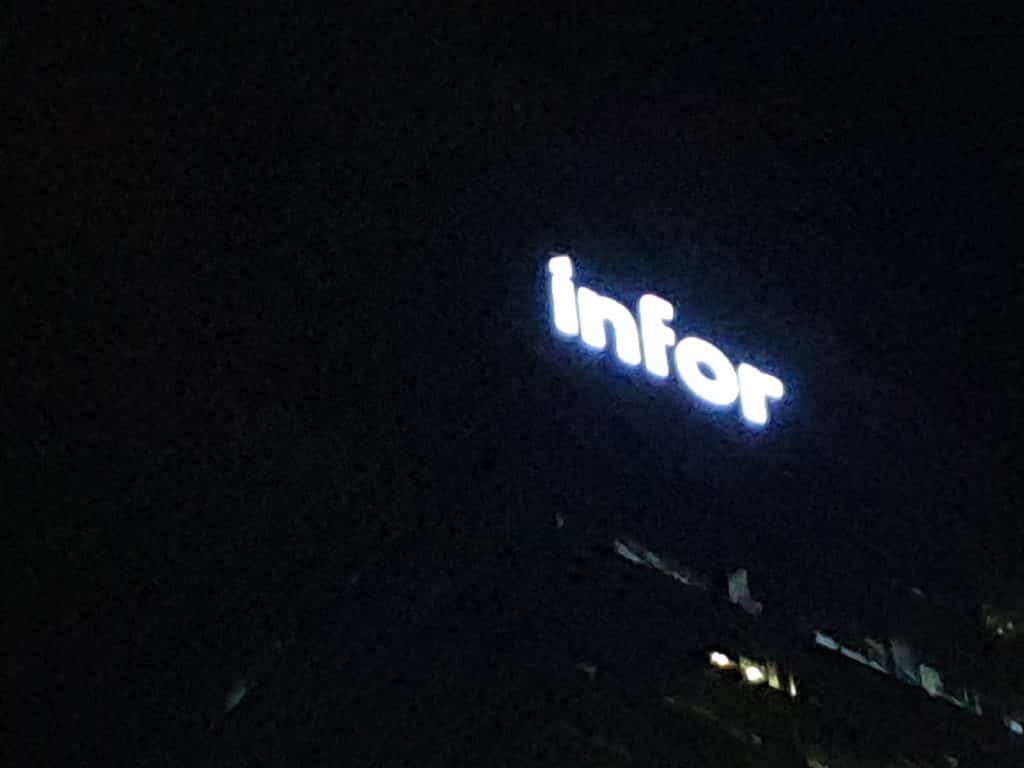 Acrylic building signage infor glowing at night atop an office in BGC, Metro Manila, by M&G Global Ads.