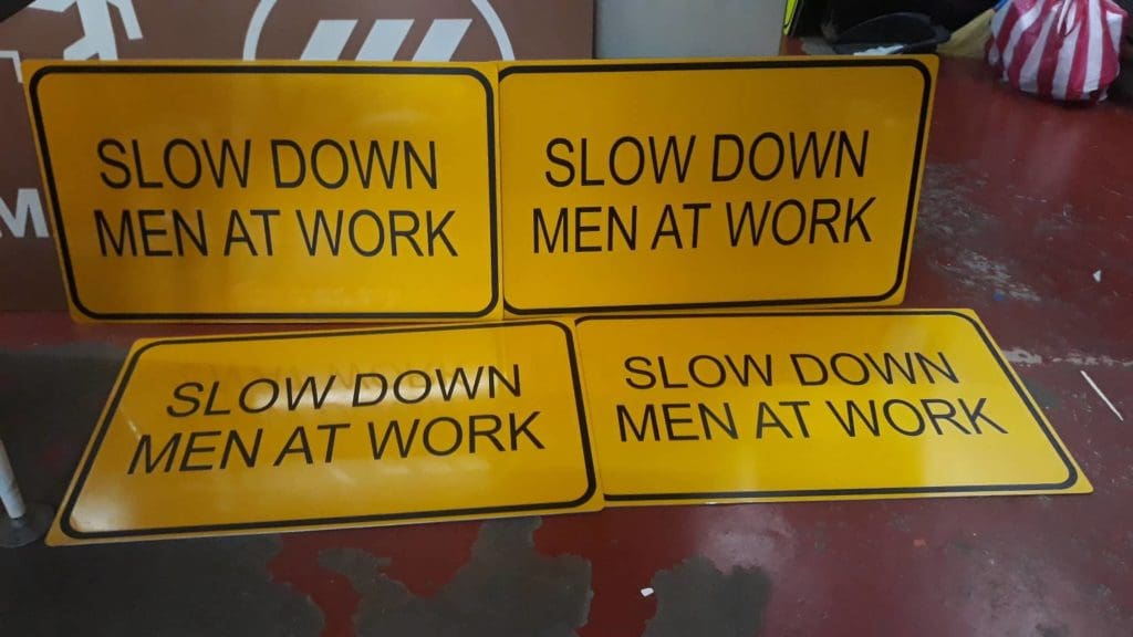 photoluminescent and evacuation map road signage for “SLOW DOWN MEN AT WORK” in Pasig, two upright and two flat, by M&G Global Ads.