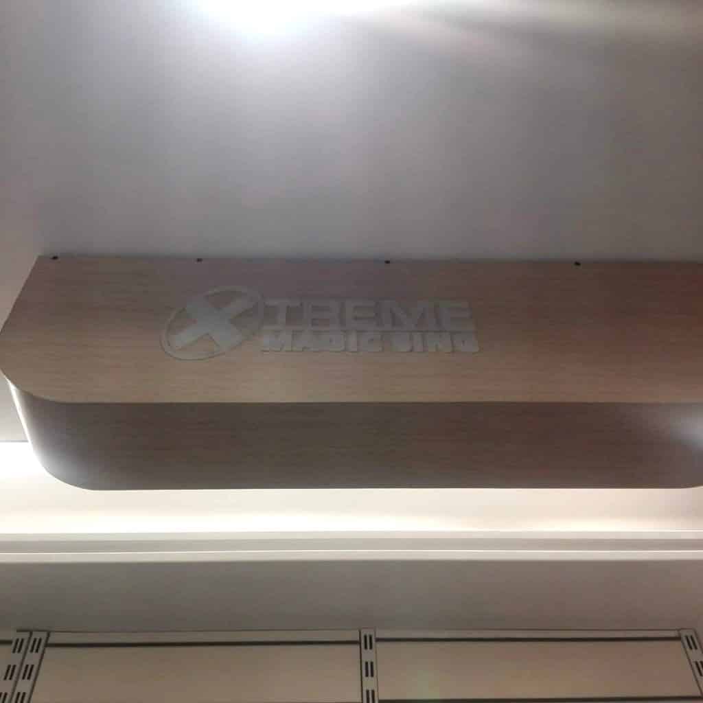 Wooden building signage for XTREME MAGIC SING with circular logo, ceiling mounted in Makati, illuminated. By M&G Global Ads.