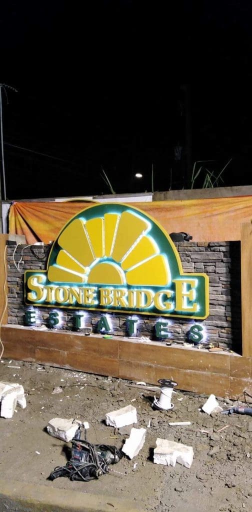 Illuminated metallic estate signage for Stonebridge in Ortigas at night, sunburst design, by M&G Global Ads.