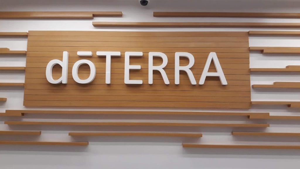 Indoor wooden wall signage for doTERRA with decorative slats, displayed in Makati office interior by M&G Global Ads.