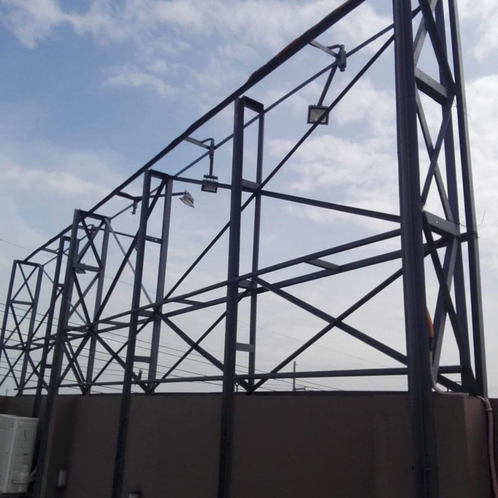 Empty pylon signage frame with mounted lights above beige wall, ready for installation in Quezon City by M&G Global Ads.