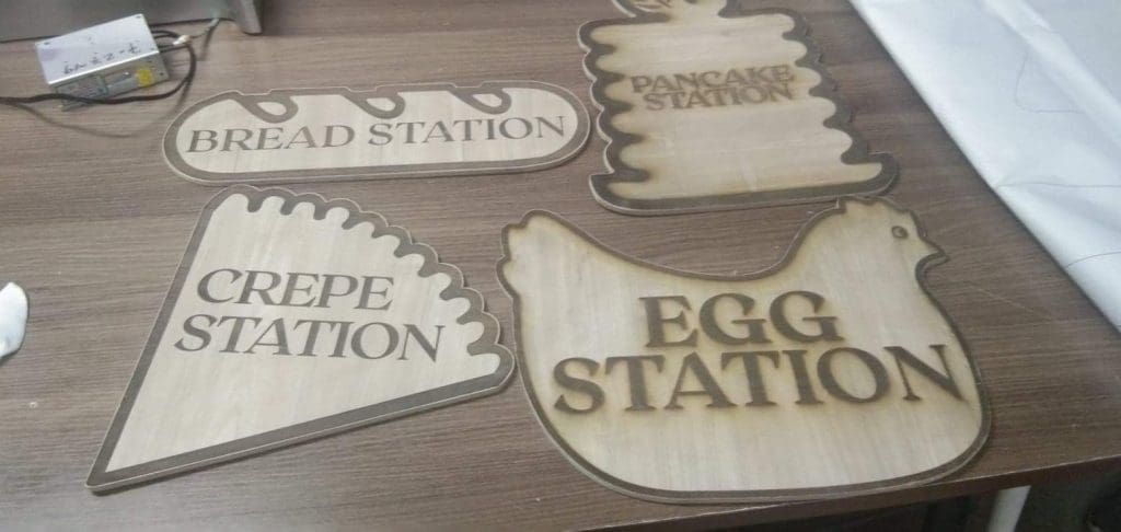 Wooden food station signage for restaurants in BGC—bread, pancake, crepe, egg—custom displays by M&G Global Ads.