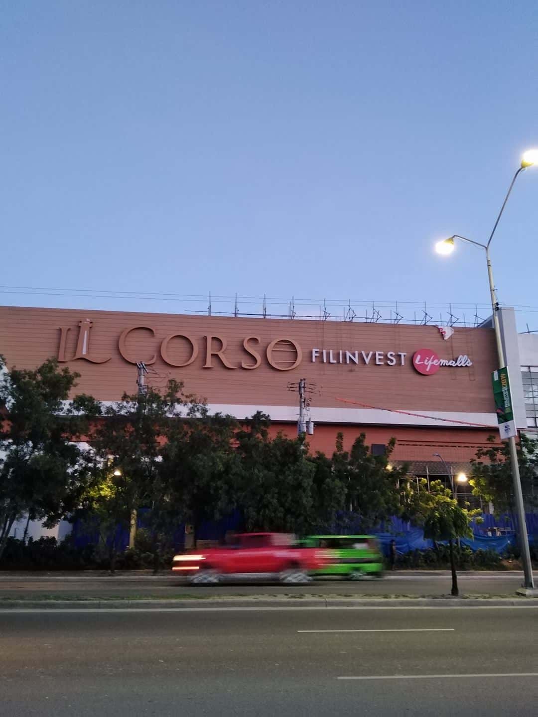Metallic outdoor signage for IL CORSO FILINVEST Lifemalls in Mandaluyong, evening view with car by M&G Global Ads.