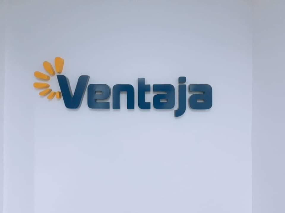 Acrylic indoor signage for Ventaja with blue letters and yellow flower petal design in Makati, by M&G Global Ads.