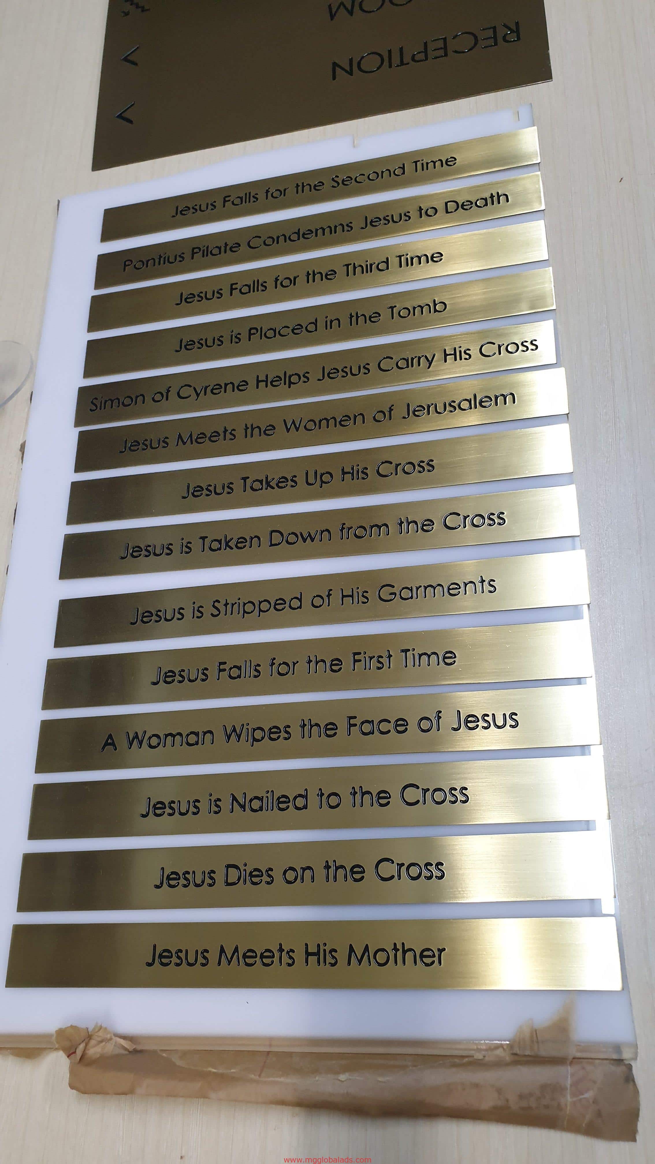 Gold metallic station of the cross plaques brass engrave signage with black text, Ortigas installation detailing Jesus journey by M&G Global Ads.