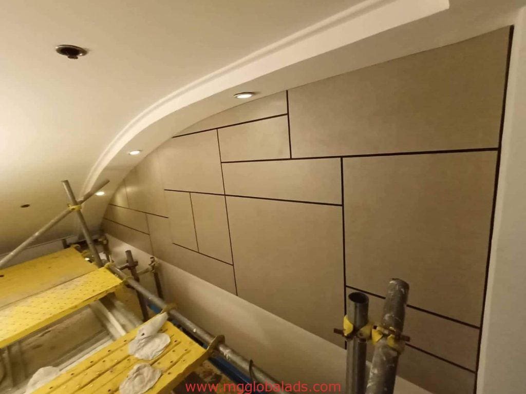 Sleek indoor wall signage installation for a client in Makati, beige geometric panels and scaffolding by M&G Global Ads.