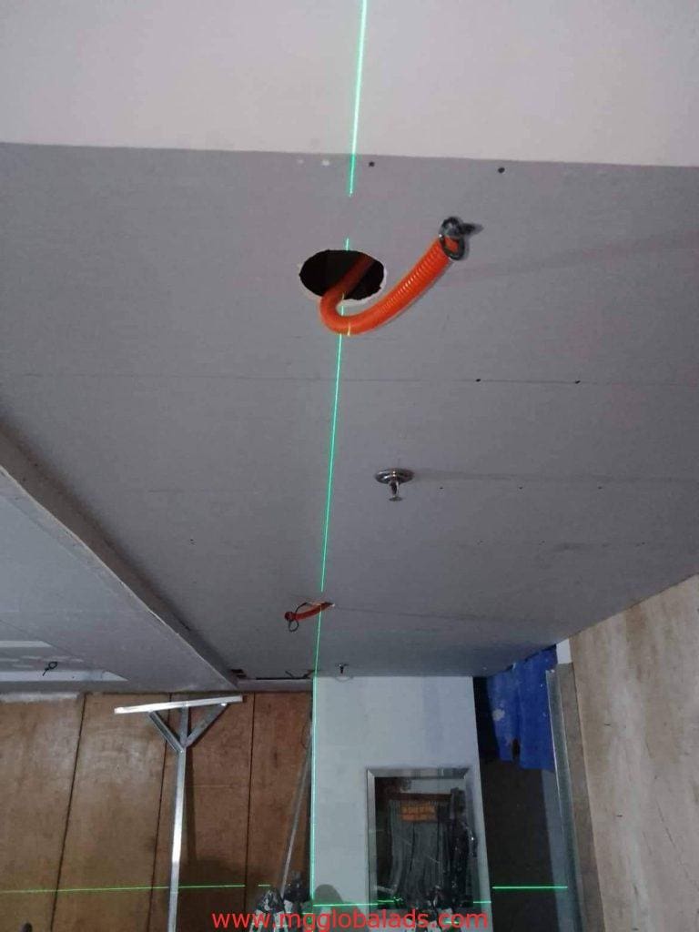 Outdoor metallic signage installation in Ortigas: ceiling cutout, conduit, and laser guides by M&G Global Ads.