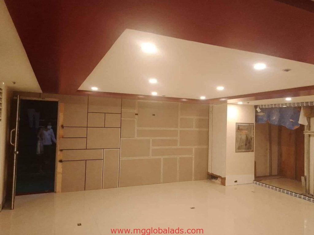 Modern empty room with geometric panels, glossy floor, and LED signage feature in Makati showroom, by M&G Global Ads.