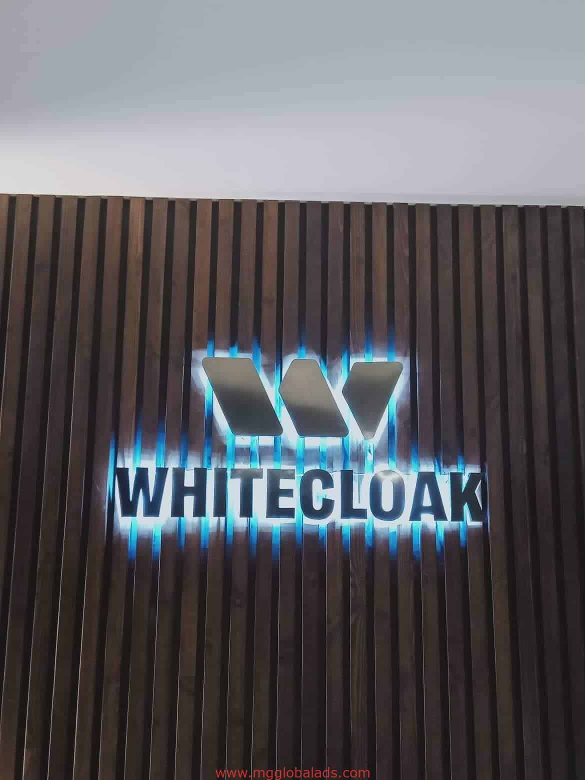 stainless signage for WHITECLOAK on wooden slat wall with blue edge lighting in Ortigas, by M&G Global Ads.