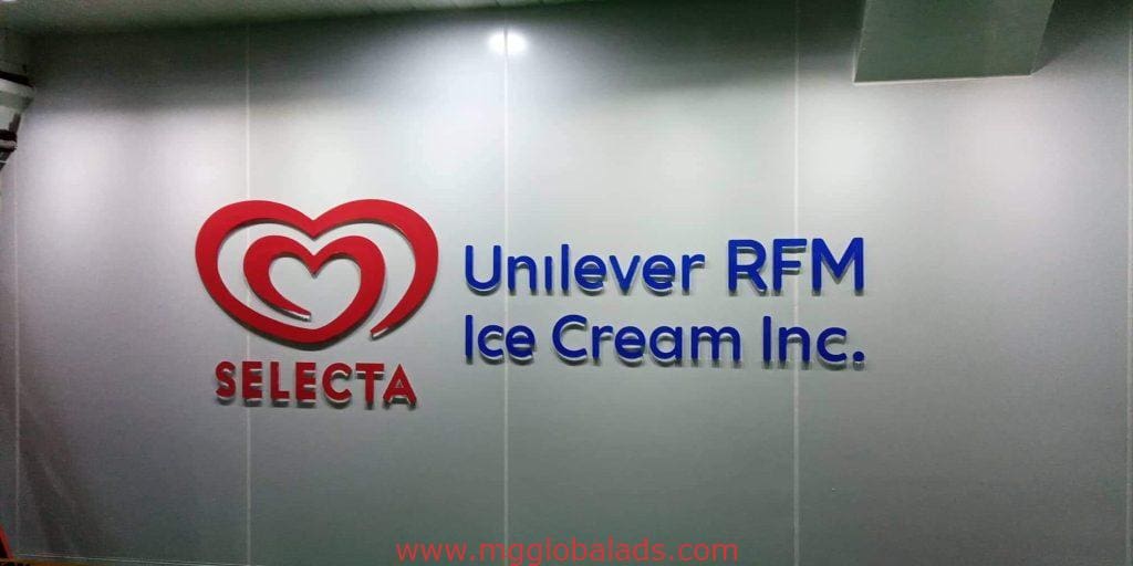 Metallic outdoor wall signage for Unilever RFM Ice Cream Inc. and Selecta, Ortigas, with logos and text by M&G Global Ads.