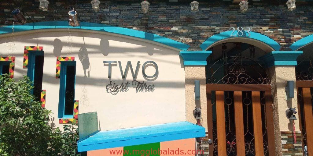 Acrylic signage for TWO Eight Three above blue and yellow facade with lantern shadows in Makati by M&G Global Ads.