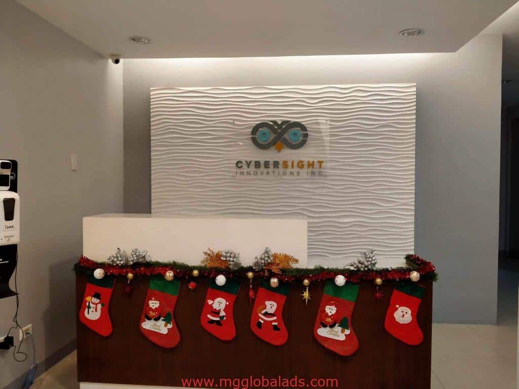 Acrylic signage for Cybersight Innovations Inc. at reception desk with Christmas stockings, Ortigas, by M&G Global Ads.