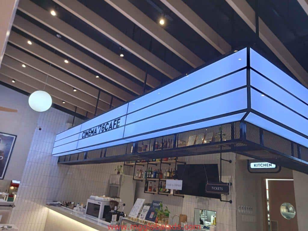 Acrylic indoor signage for CINEMA V6 CAFÉ in Makati with digital KITCHEN sign, modern cafe interior by M&G Global Ads.