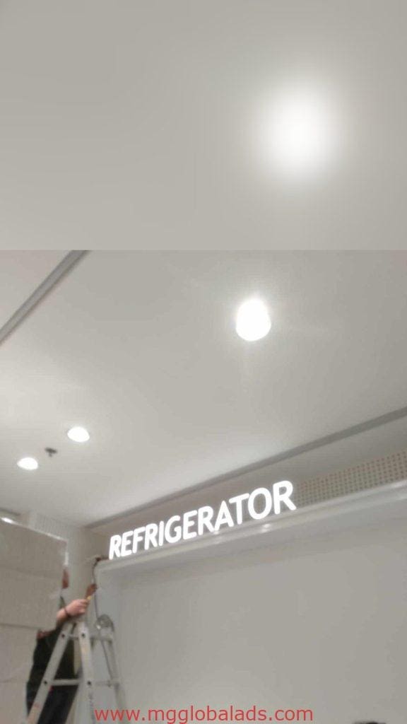 Illuminated acrylic REFRIGERATOR signage installation on indoor ceiling in Makati, bright lights nearby, by M&G Global Ads.
