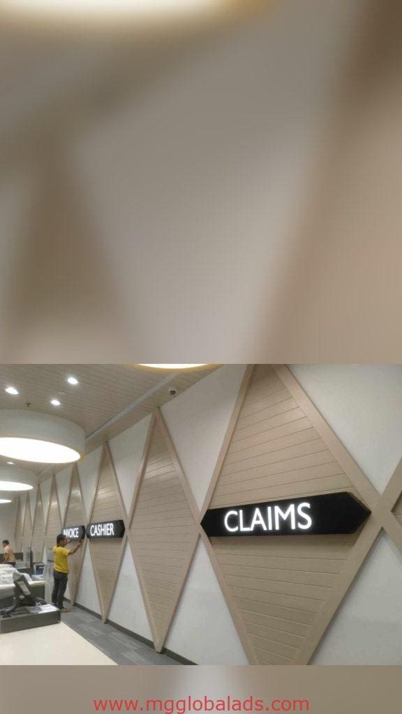 LED office signage INVOICE, CASHIER, CLAIMS at service counter in modern Makati building, diamond wall panels by M&G Global Ads.