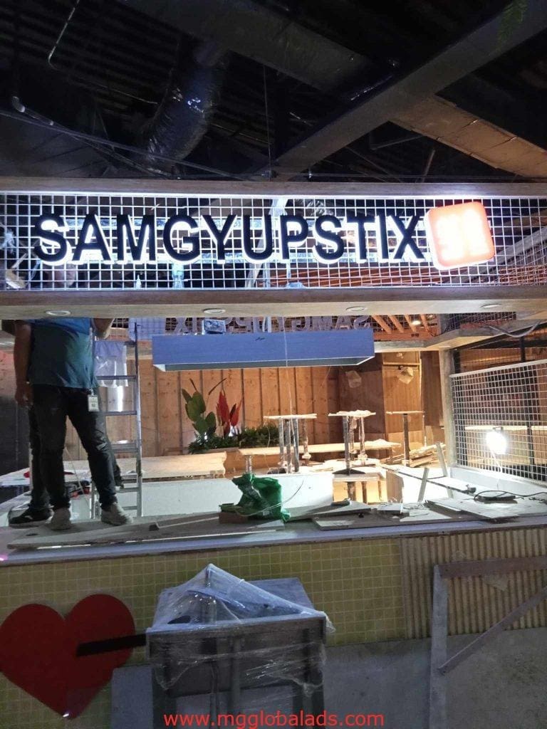Metallic LED signage SAMGYUPSTIX at food stall under construction in Quezon City by M&G Global Ads.