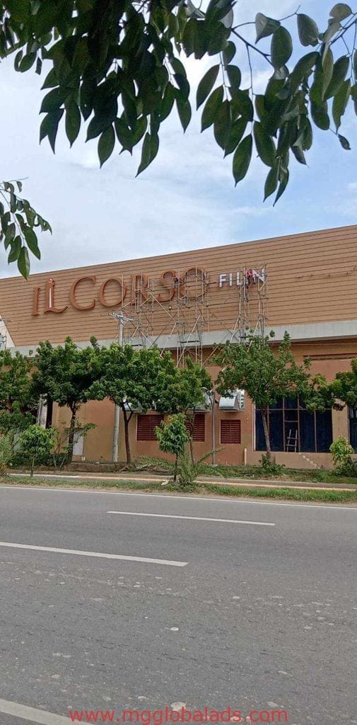 Installing large metallic building facade signage for ILCORSO FILINVEST in Quezon City by M&G Global Ads.