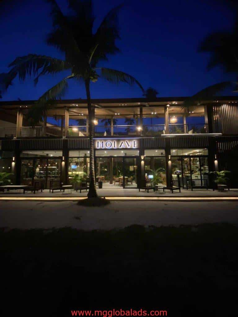 Molave restaurant with LED signage, warmly lit at night in Makati, inviting entrance and windows, by M&G Global Ads.