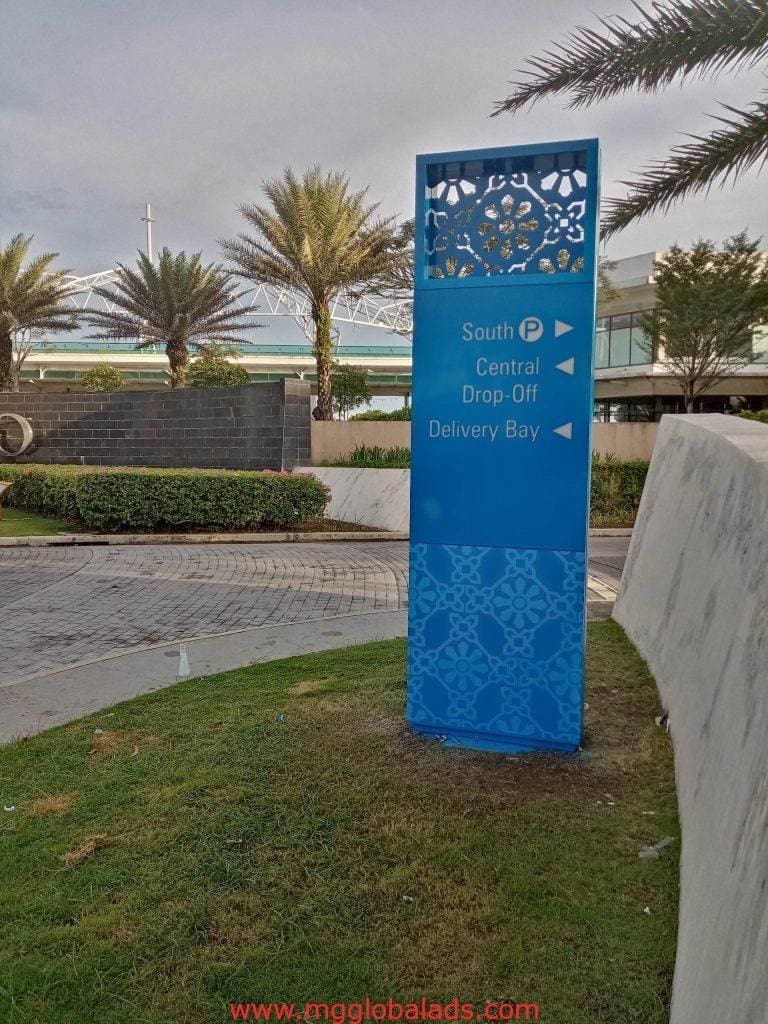 Outdoor directional signage for Central drop-off and Delivery Bay at Quezon City site, blue metal design, by M&G Global Ads.