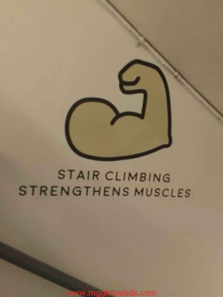 Acrylic signage in Makati with illustration of flexed arm and text Stair climbing strengthens muscles by M&G Global Ads.