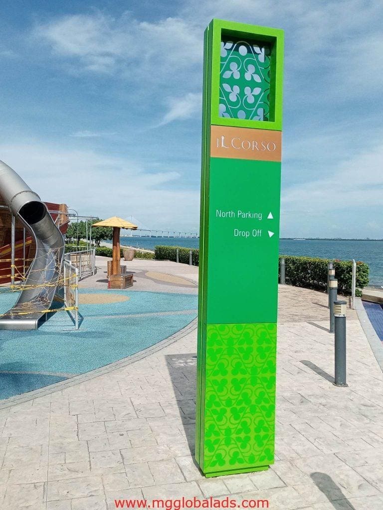 Wayfinding totem sign for il Corso points to North Parking and Drop Off, with playground & waterfront, in BGC by M&G Global Ads.