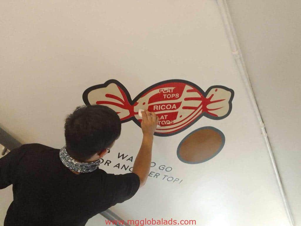 Creative building signage for FLAT TOPS RICOA in Quezon City being hand-painted on a white ceiling by M&G Global Ads.