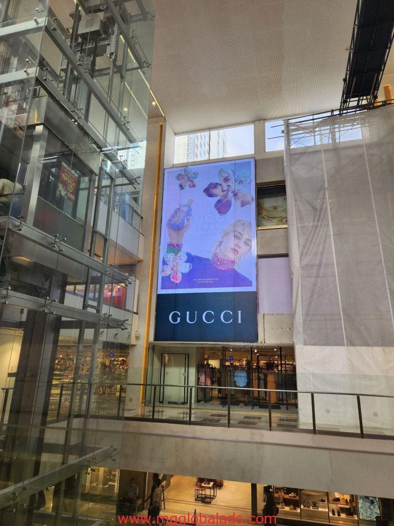 Gucci illuminated indoor signage at a Makati mall with floral designs and models face by M&G Global Ads.