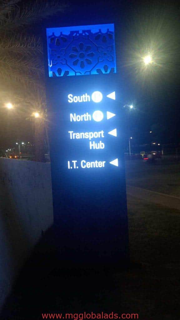 LED wayfinding signage at night in Makati showing directions to South, North, Transport Hub, I.T. Center by M&G Global Ads.