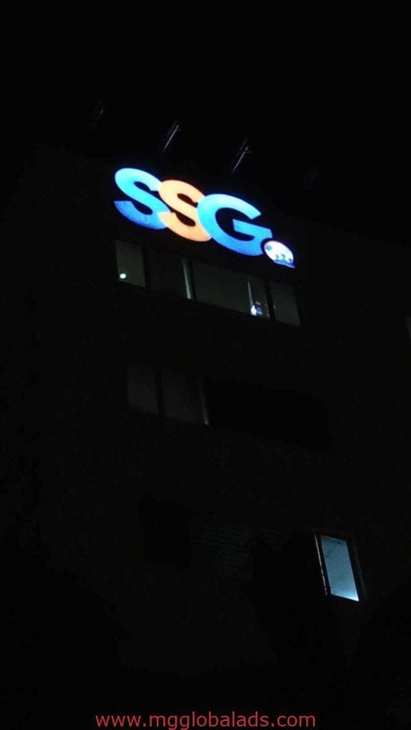 Illuminated outdoor signage SSG in metallic letters and small 22 sign on building in Makati by M&G Global Ads.