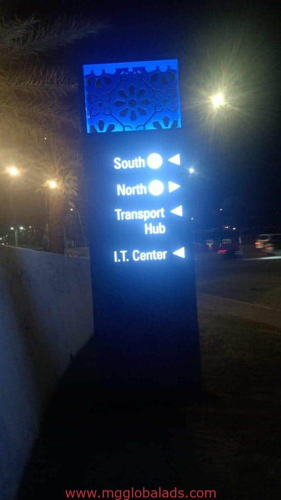 Illuminated wayfinding signage at night in Ortigas showing directions to South, North, Transport Hub by M&G Global Ads.