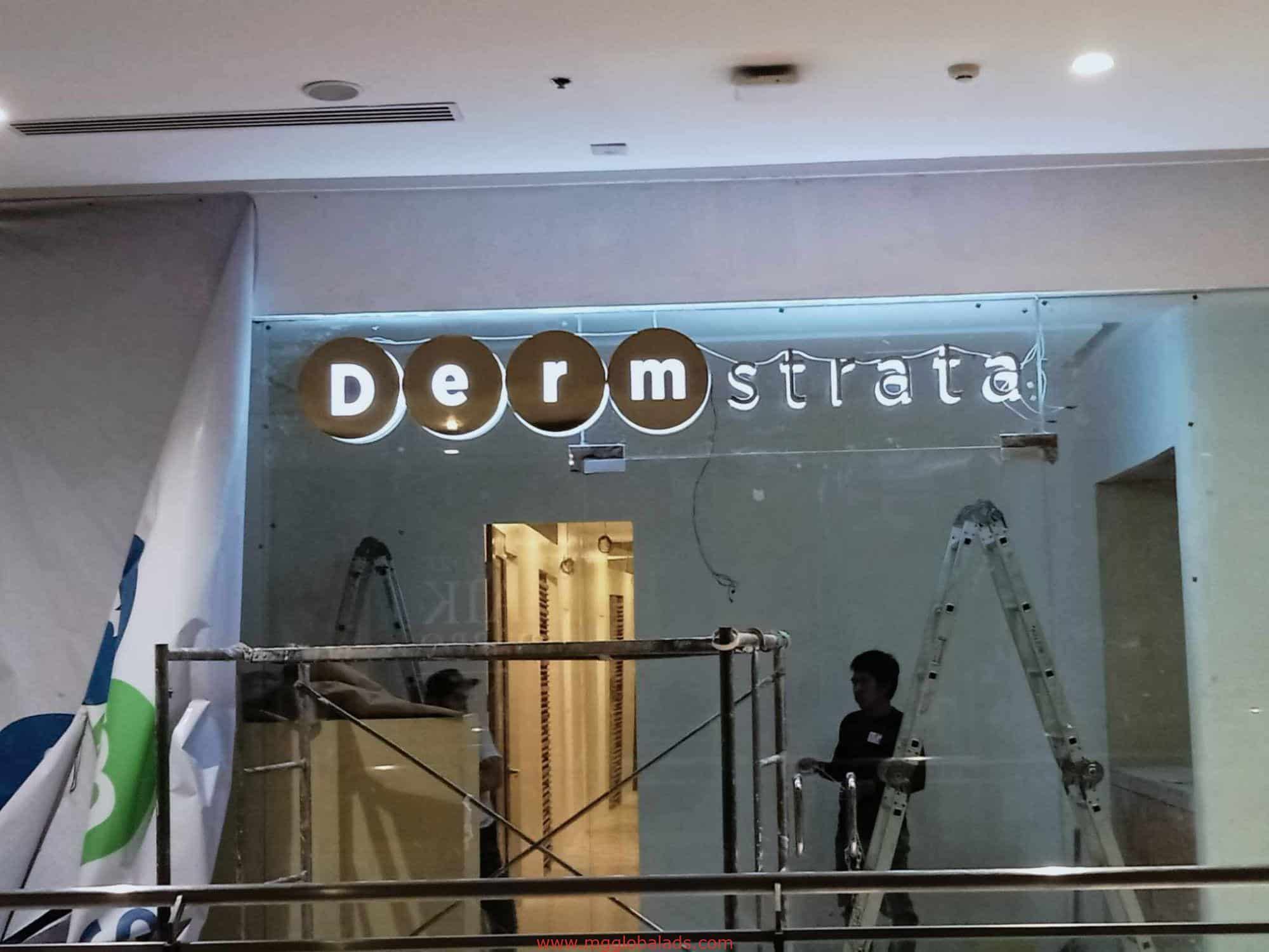 brass sign | derm strata