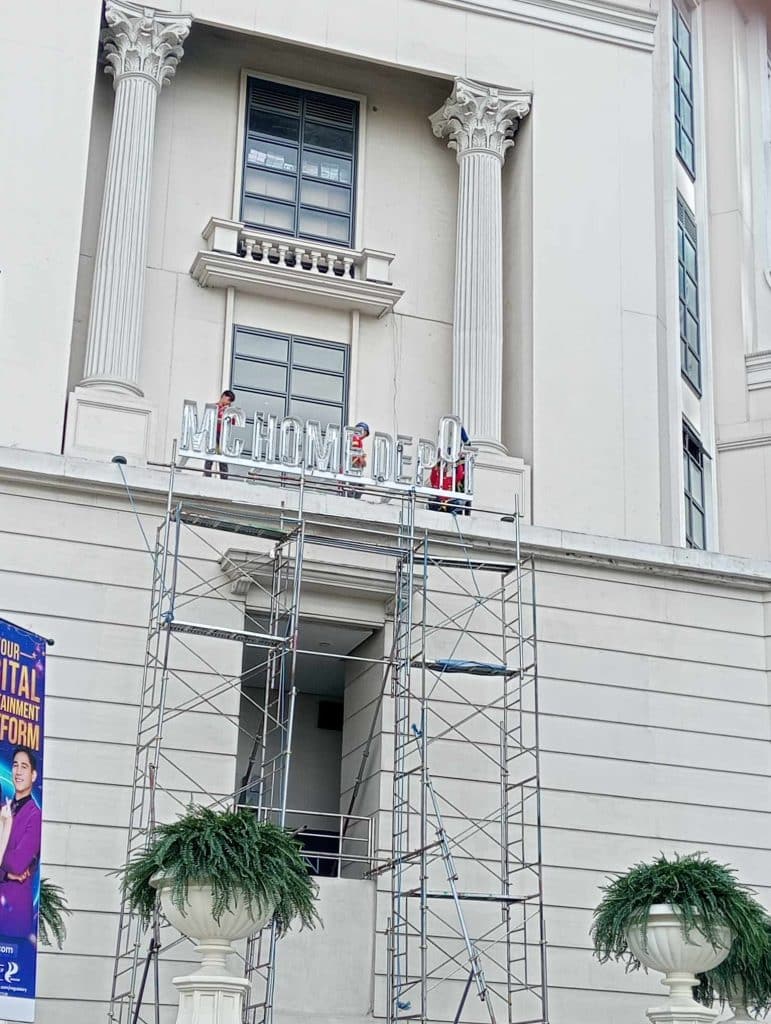 MC HOME DEPOT outdoor acrylic signage installation on neoclassical building facade in Ortigas by M&G Global Ads.