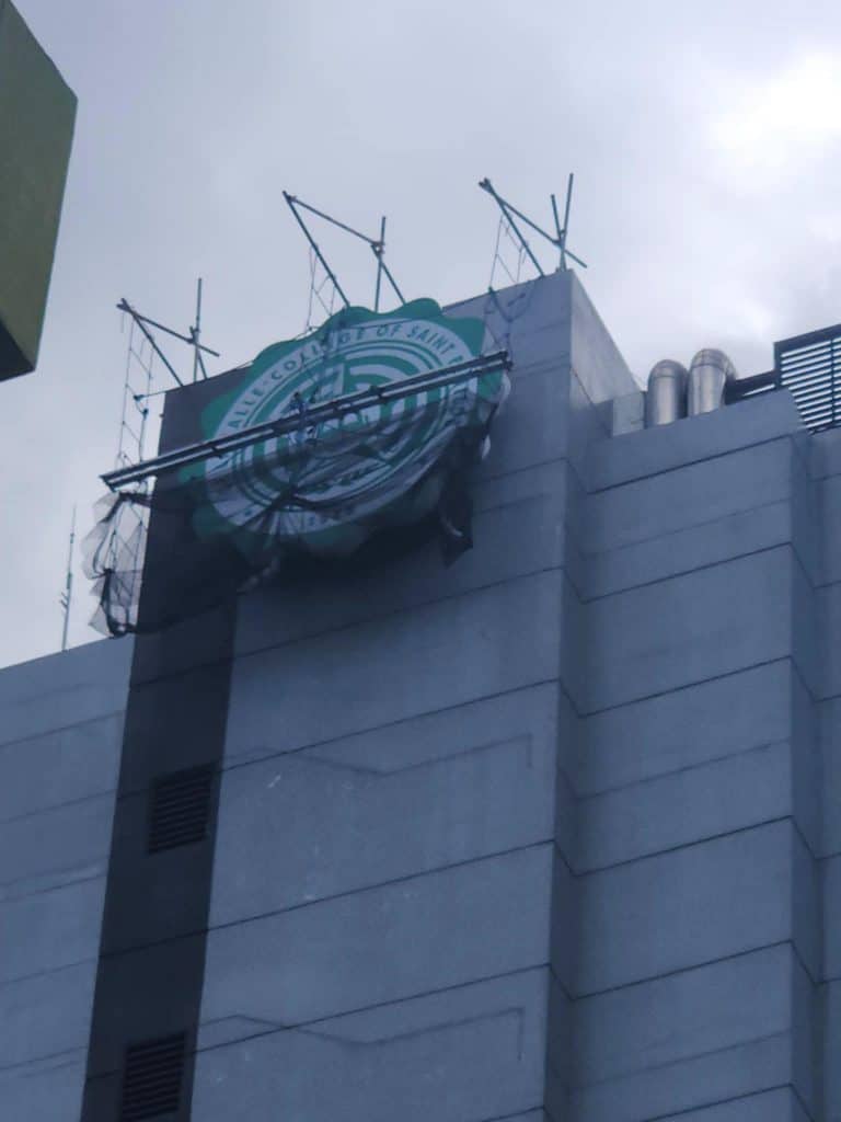 LED building signage installation on top of a tall gray building in Ortigas under construction by M&G Global Ads.