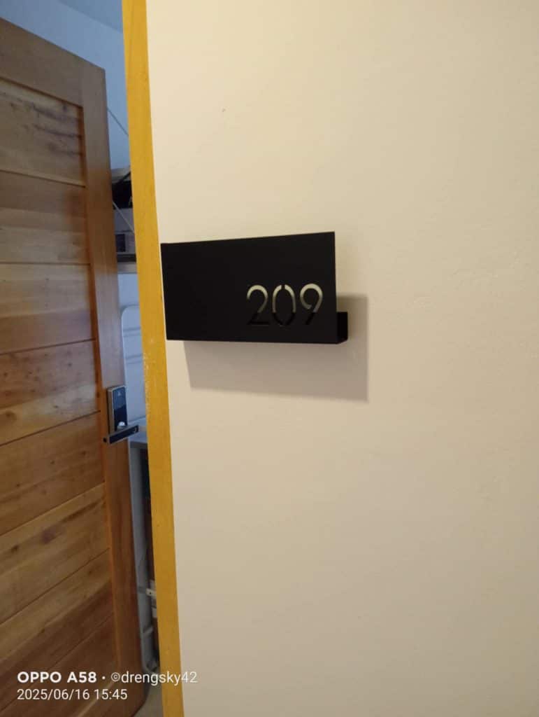 Room number signage 209 in metallic letters on black plaque by door in Ortigas, Metro Manila, by M&G Global Ads.