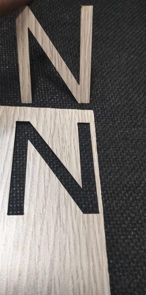 Wooden indoor signage letter N cutout over matching board on dark surface, ideal for offices in Mandaluyong by M&G Global Ads.