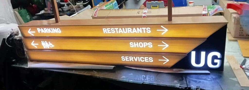 Indoor illuminated acrylic wayfinding signage with UG letters for parking, shops, services, Metro Manila. Sign maker Philippines by M&G Global Ads.
